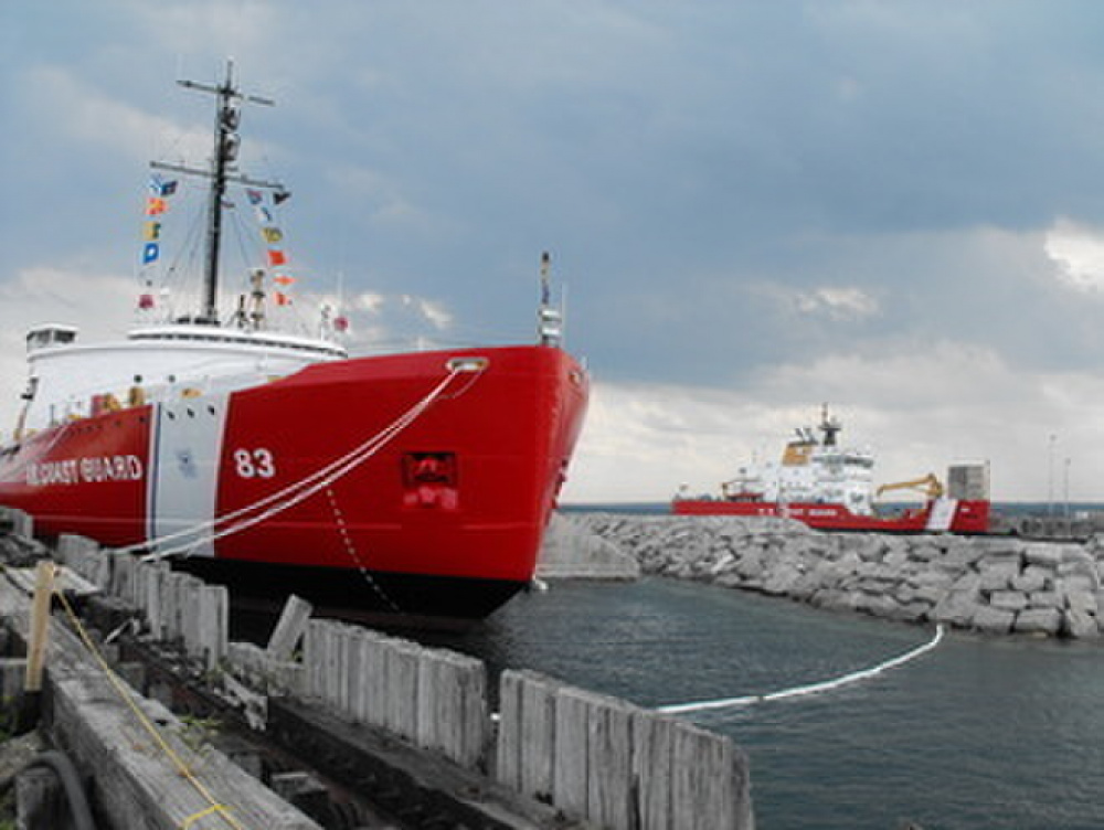 Photo showing the decommissioned “Big Mac” and the new replacement icebreaker Mackinaw in the background. (U.S. Coast Guard)