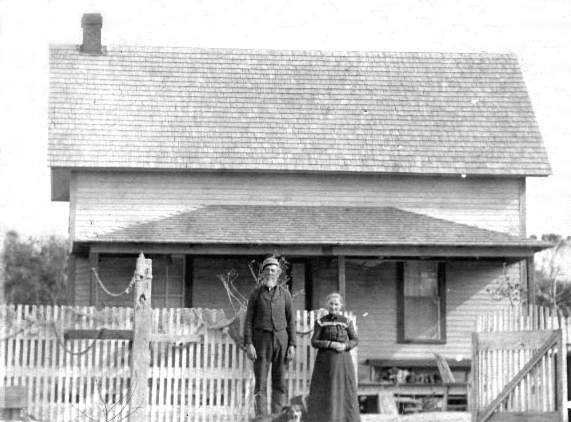 Photograph of Benjamin Dailey and wife Josephine standing in front of their modest home located on the Outer Banks of North Carolina. (U.S. Coast Guard)