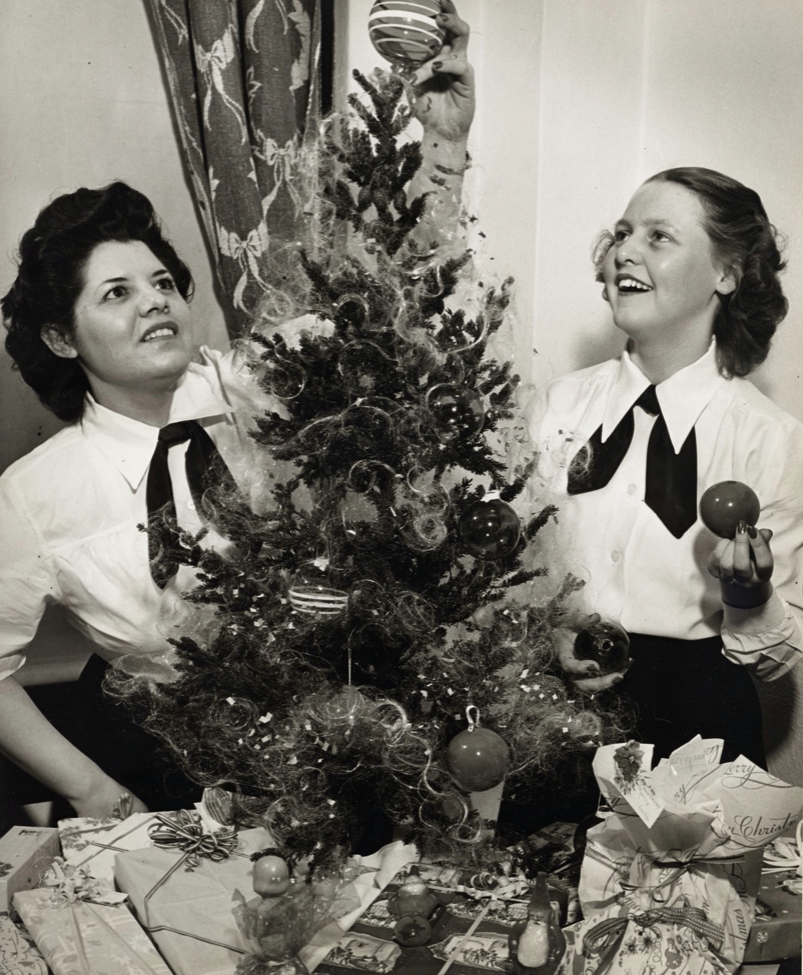 Petty Officer 3rd Class Maria Nunez (left), a SPAR from Tucson, Arizona, prepares to celebrate Christmas with 300 other SPARs at the SPAR barracks located in Cleveland, Ohio. (Coast Guard photo)