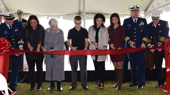 Members from the Coast Guard, New York City Fire Department, and Palazzo family participate in the ribbon cutting when the new Jeff Palazzo Hall was dedicated at Coast Guard Station New York in October 2016. (U.S. Coast Guard photo by Petty Officer 3rd Class Steve Strohmaier)