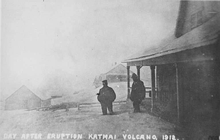 Two unidentified men attempt to slog through the ash drifts the day after the eruption. (Wikimedia)