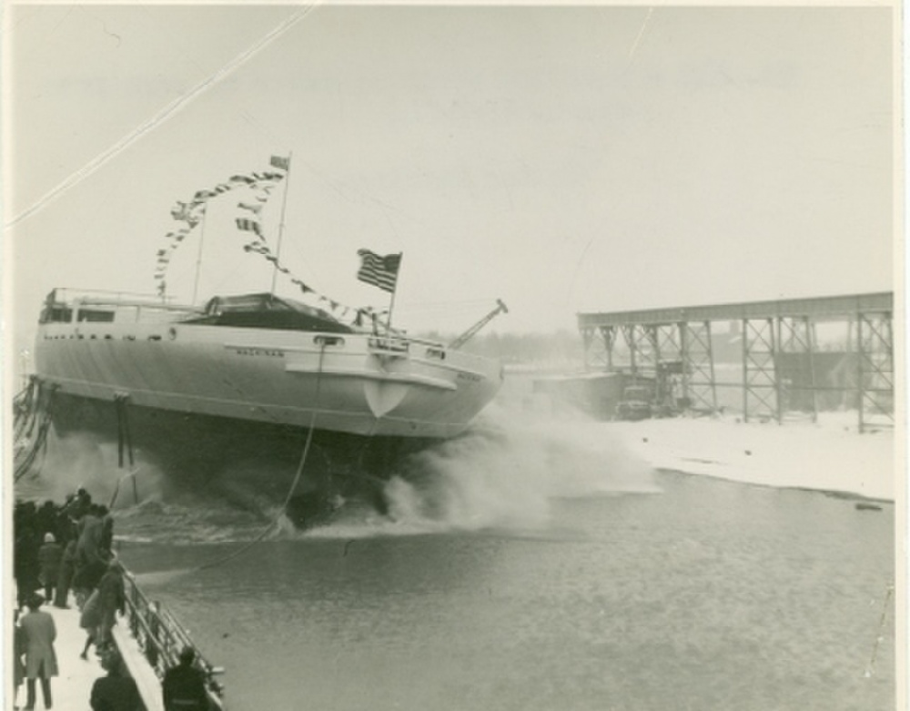 Launch day at Toledo Shipbuilding showing the extreme width of Mackinaw’s hull. Great Lakes shipyards often launched hulls sideways due to the yards’ riverside locations. (U.S. Coast Guard Photo)